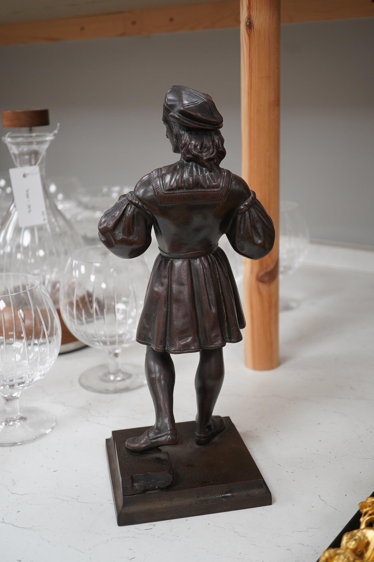 A cast iron figure of a scribe, with bronzed patina, 33cm high. Condition - good